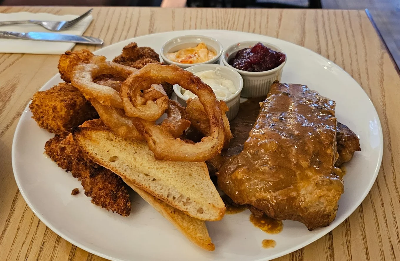 Pub exterior with horse-drawn carriage passing by