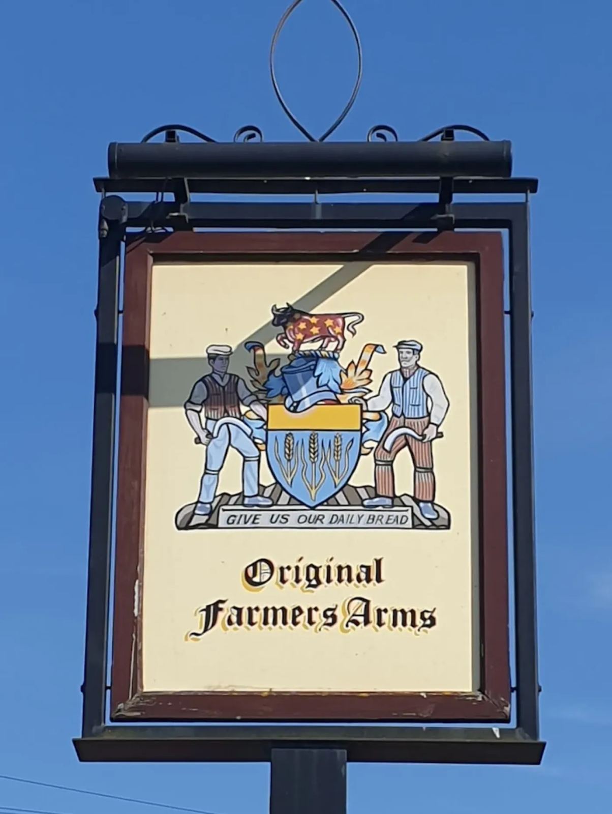 Traditional hanging pub sign with heraldic crest